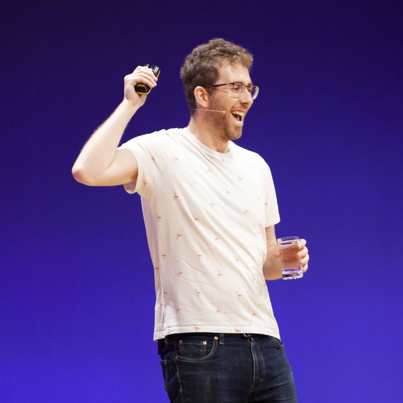 Me smiling happily with my mouth open while giving a talk on stage